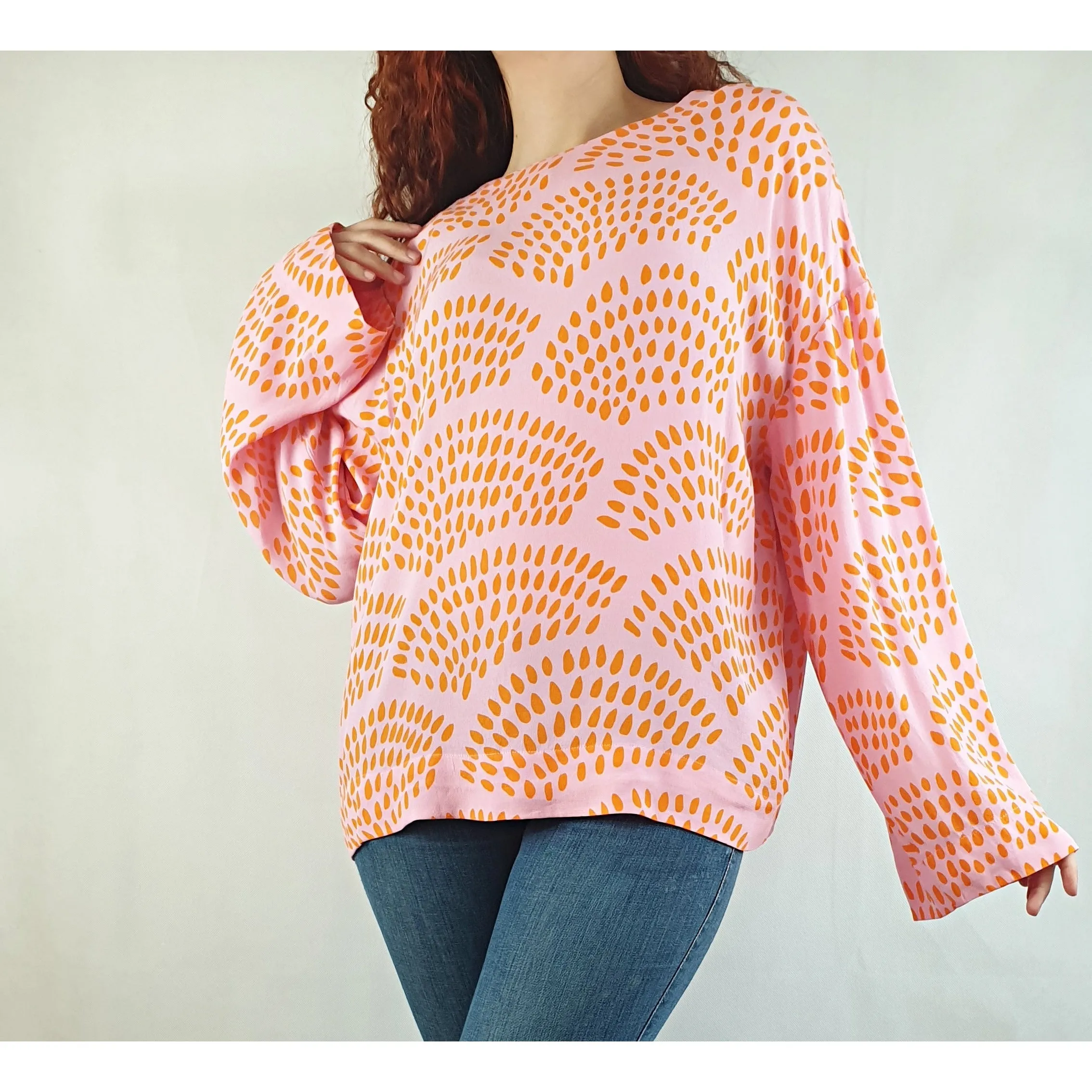 Bright pink pre-owned long sleeve top with orange print size SM (fits sizes 10-12)